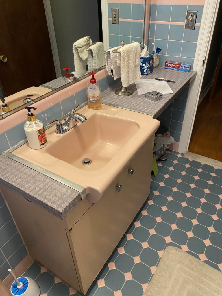 bathroom with blue tile and light orange sink