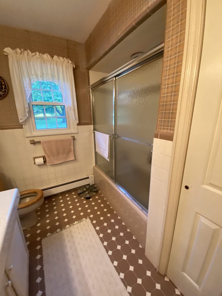 sliding glass door shower in brown bathroom