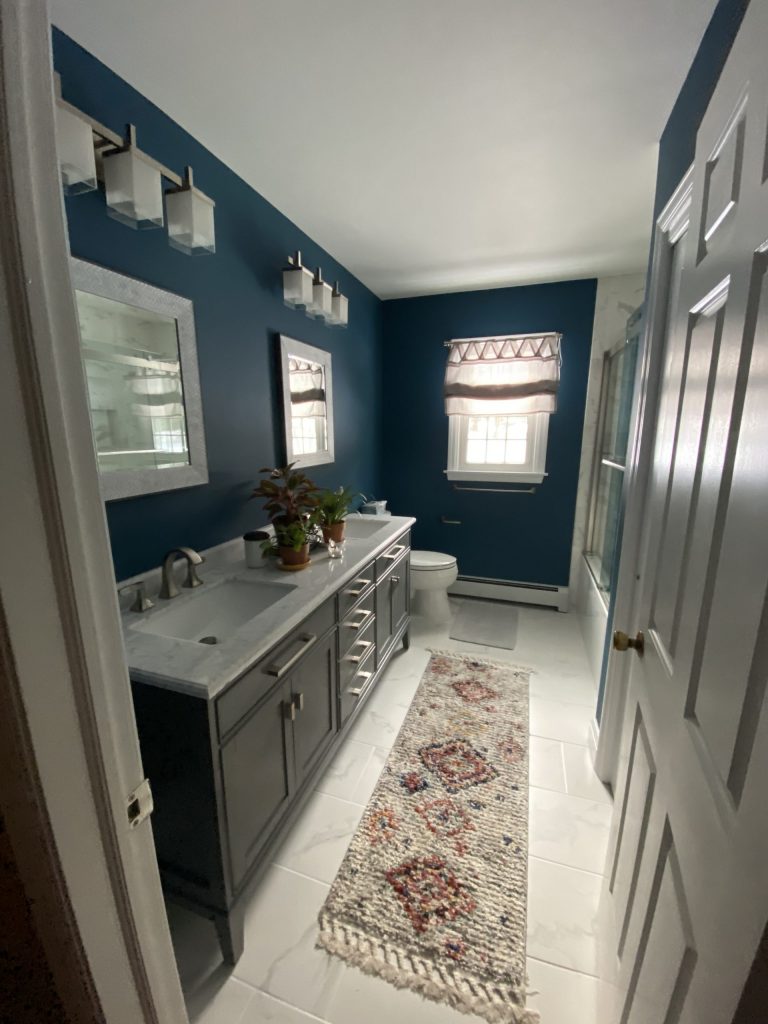 bathroom with blue wall, carpet on floor